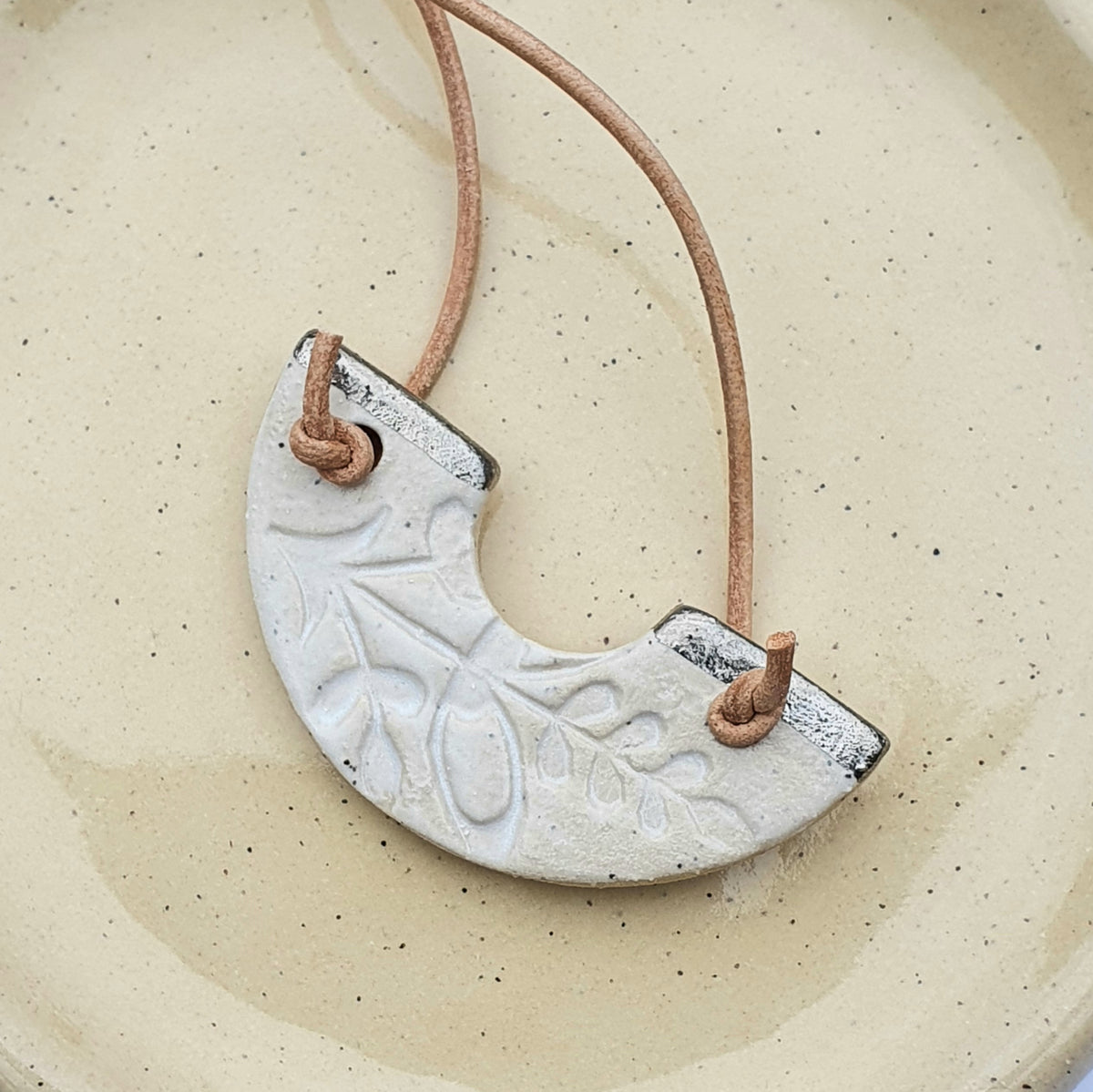 Speckled clay necklace - U shape, white glaze with platinum lustre detailing