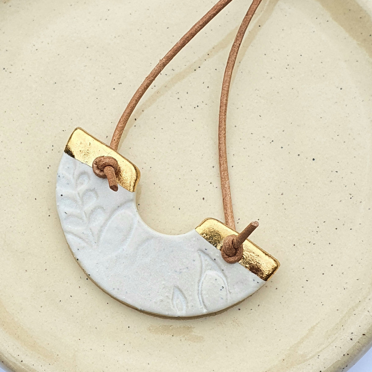 Speckled clay necklace - U shape, white glaze with gold lustre detailing